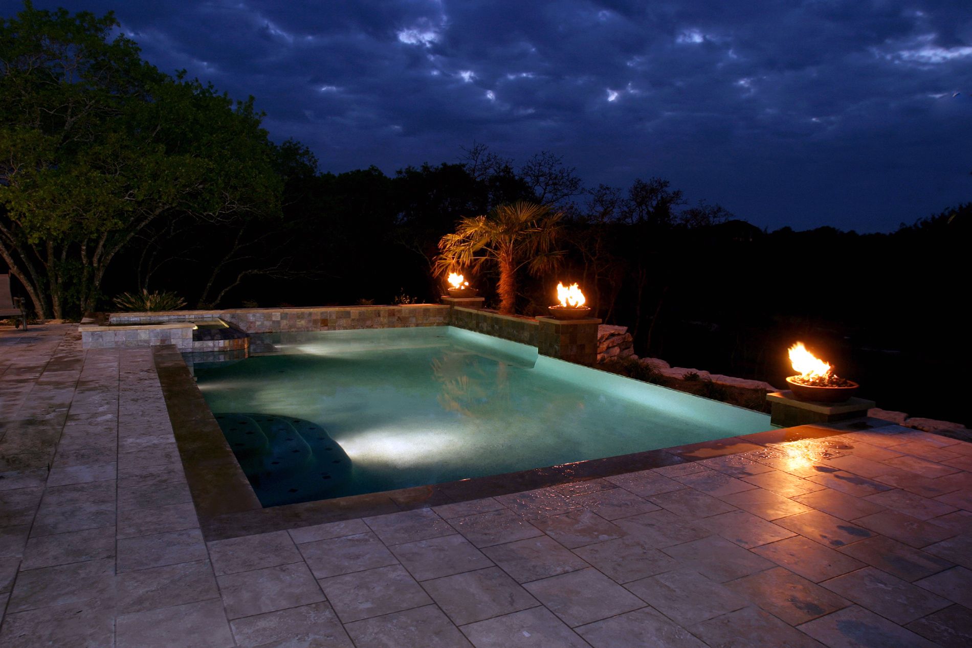 Classic style pool with corner fire places