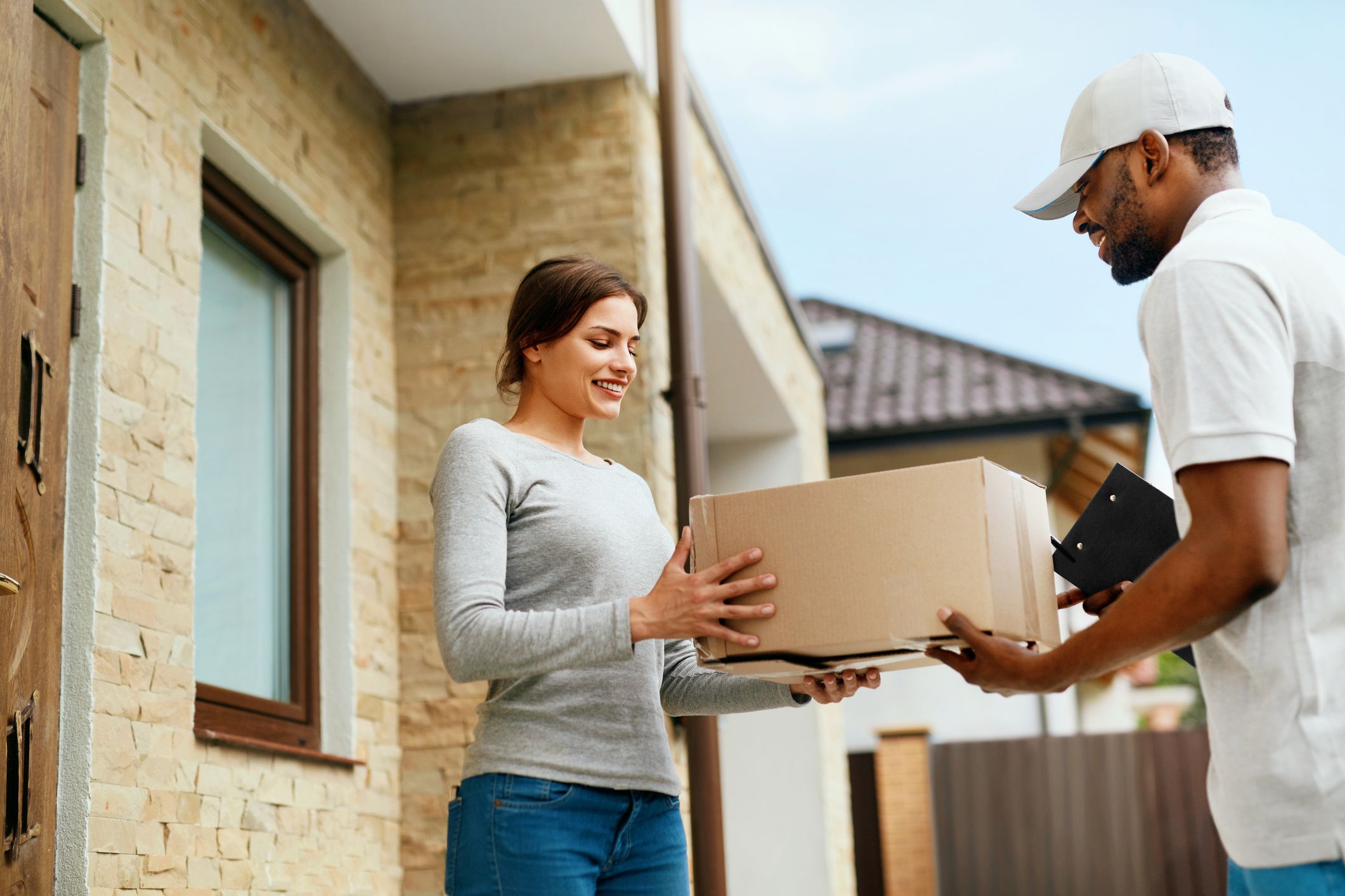 Image of a delivery guy handing out package Home Delivery