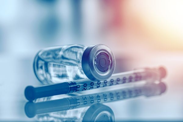 Image of a syringe and vaccine vial Immunizations