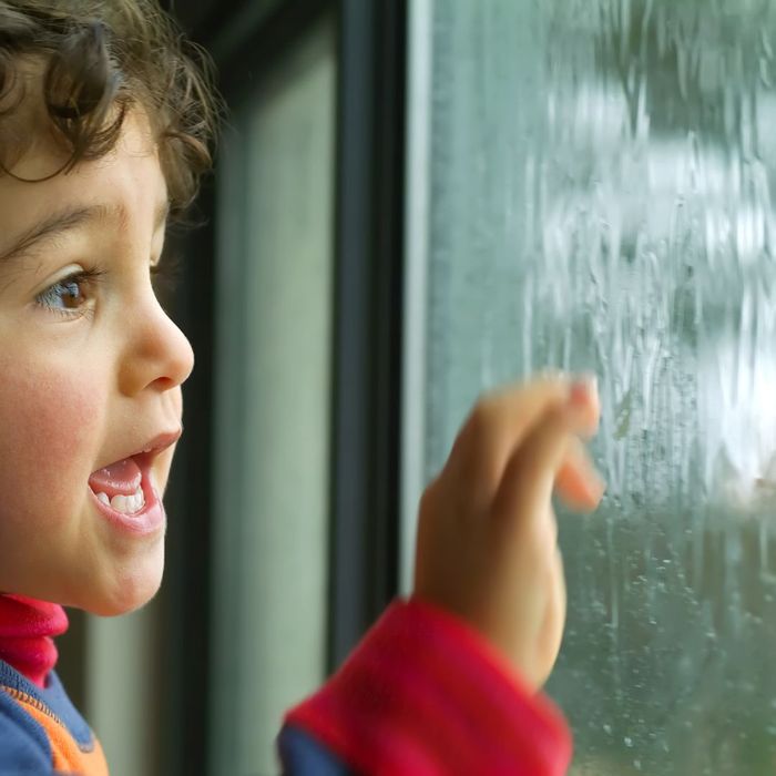 child looking outside during a storm