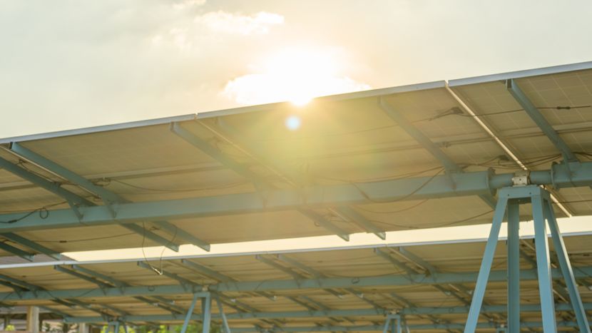 Sun above solar panels