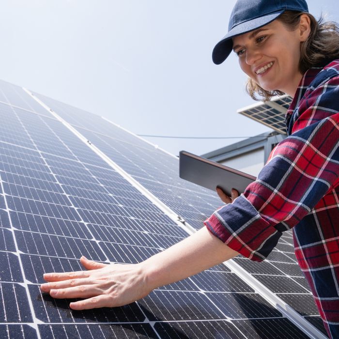 Woman with clean solar panel