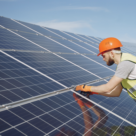 Man fixing solar panels
