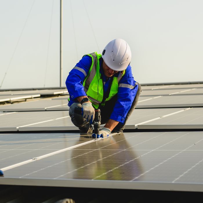 certified electrician working on solar panels