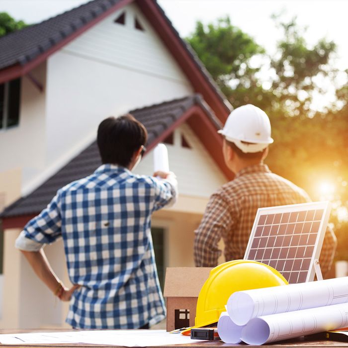 workers planning solar panels for a home