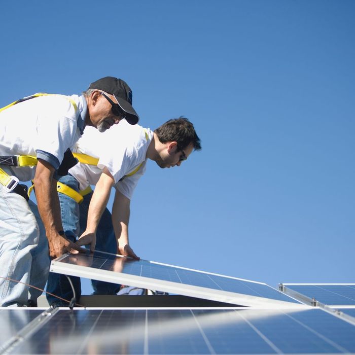 people installing solar panels