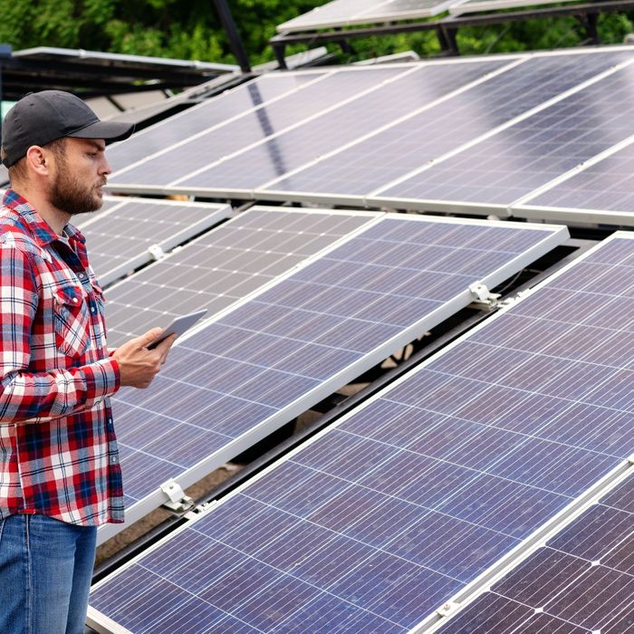 Man checking solar panels