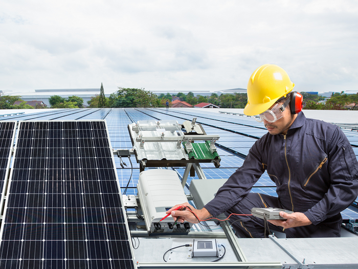 Solar technician working on solar panels