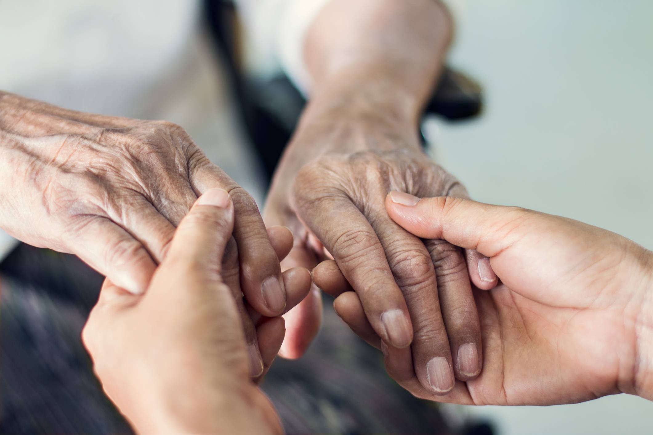 Elderly holding hands