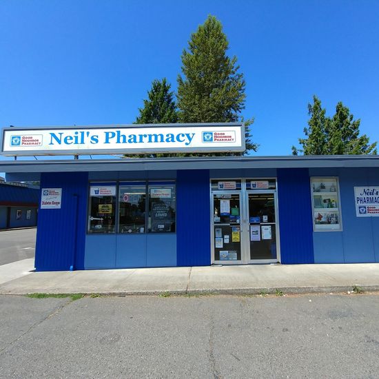 Blue building with a Neil's Pharmacy sign Neil's Pharmacy