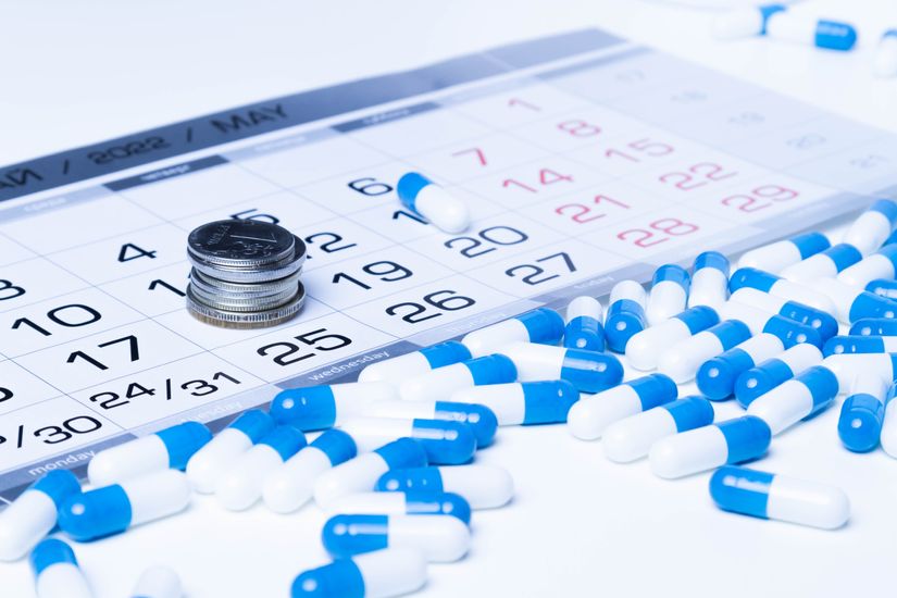Blue medicine organized on a calendar Medication Synchronization