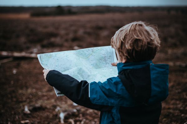 Boy examining a Map (annie-spratt).jpg