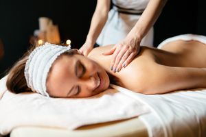 massage-therapist-massaging-woman-HYQ8E3V.jpg