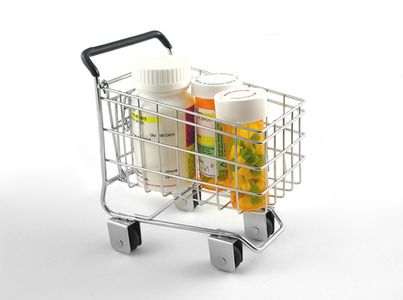 Various pills in a miniature shopping cart Prescription delivery