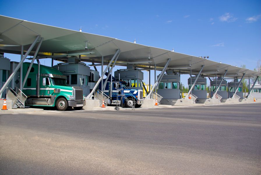 Semi-trucks-pay-at-tollbooth-at-Canadian-border-000034492786_Large.jpg