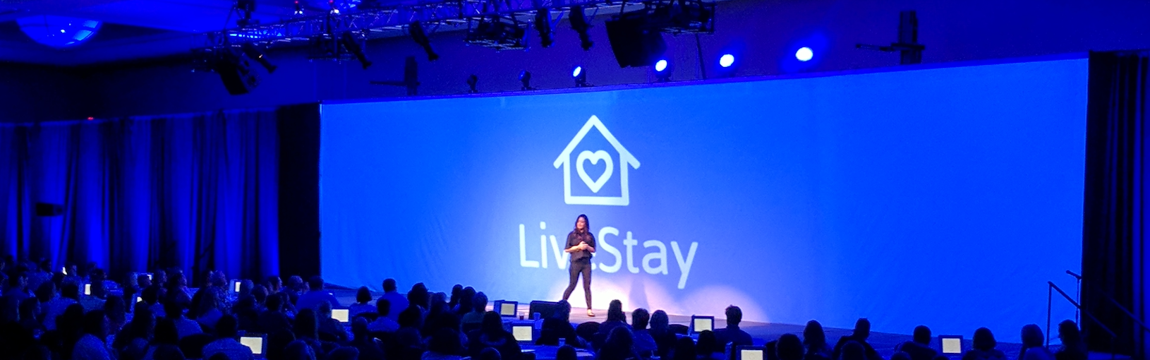 Large Conference Stage with a projection display and blue lighting