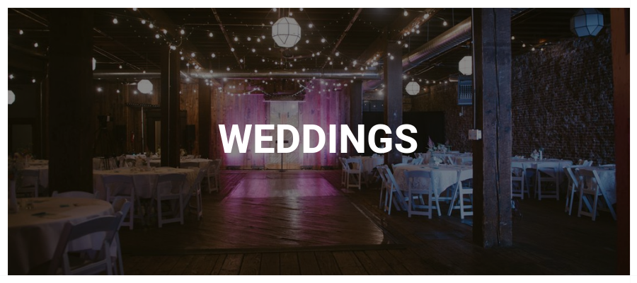 Wedding Button with an empty reception room with string lighting in the background