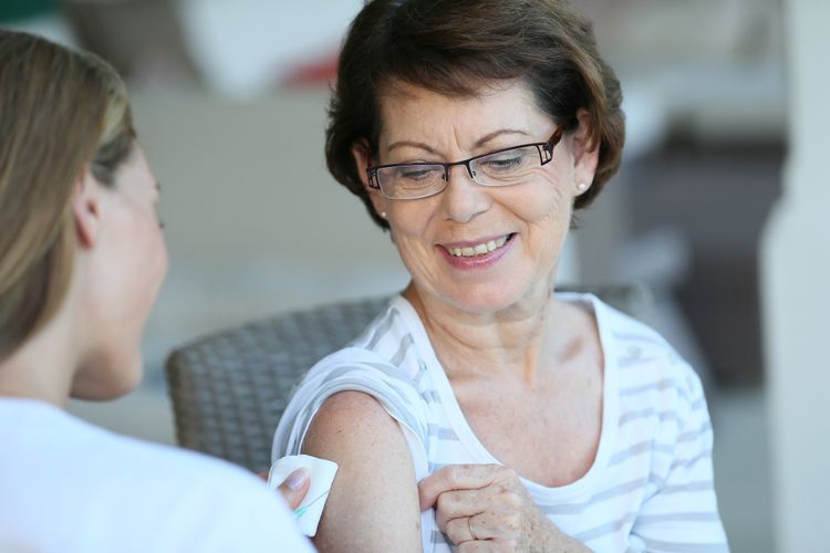 Woman receiving a vaccine Flu Vaccine