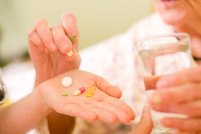 Image of an elderly woman choosing medication Medication Therapy Management