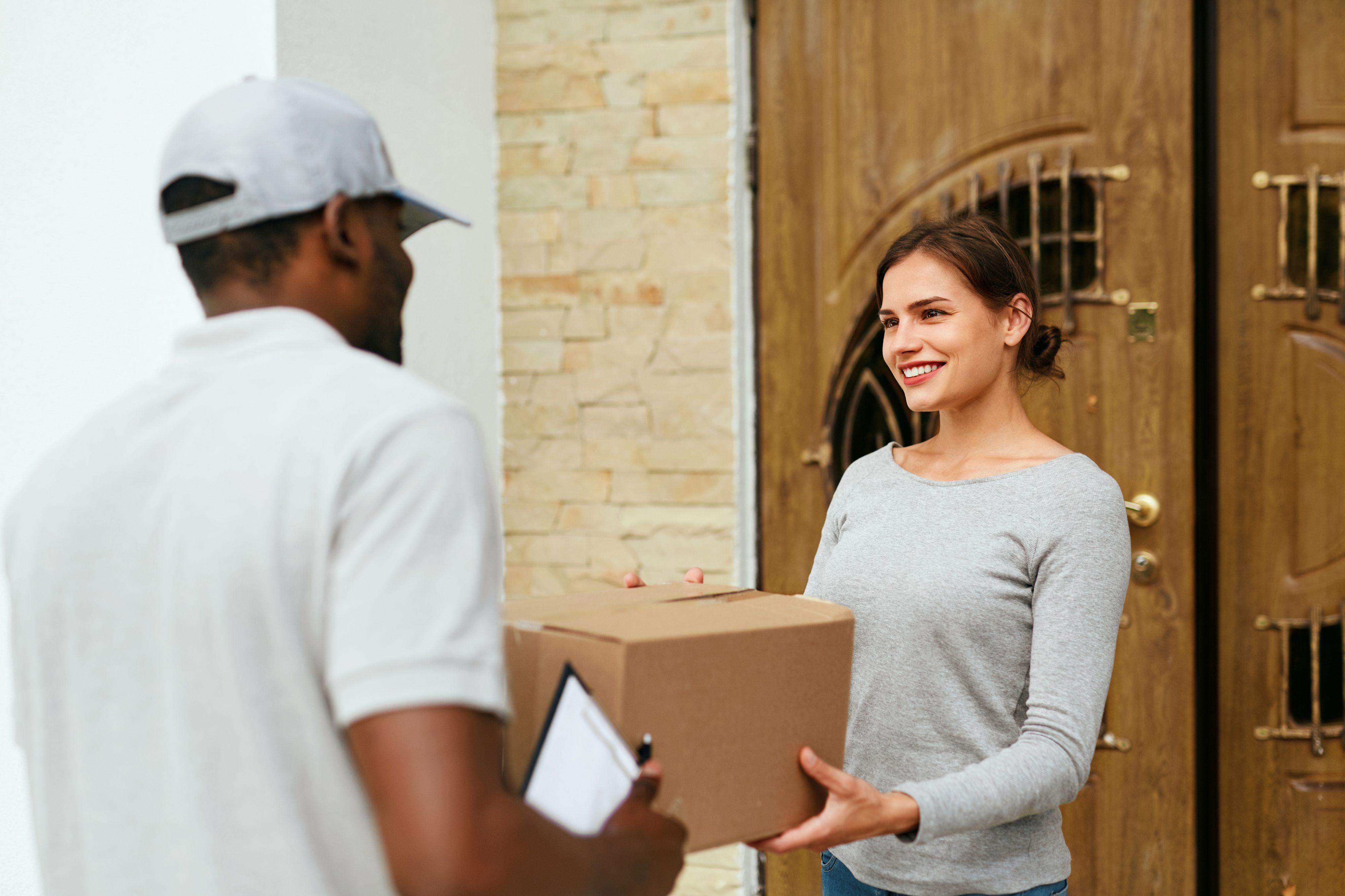 Image of a delivery guy handing out package Delivery
