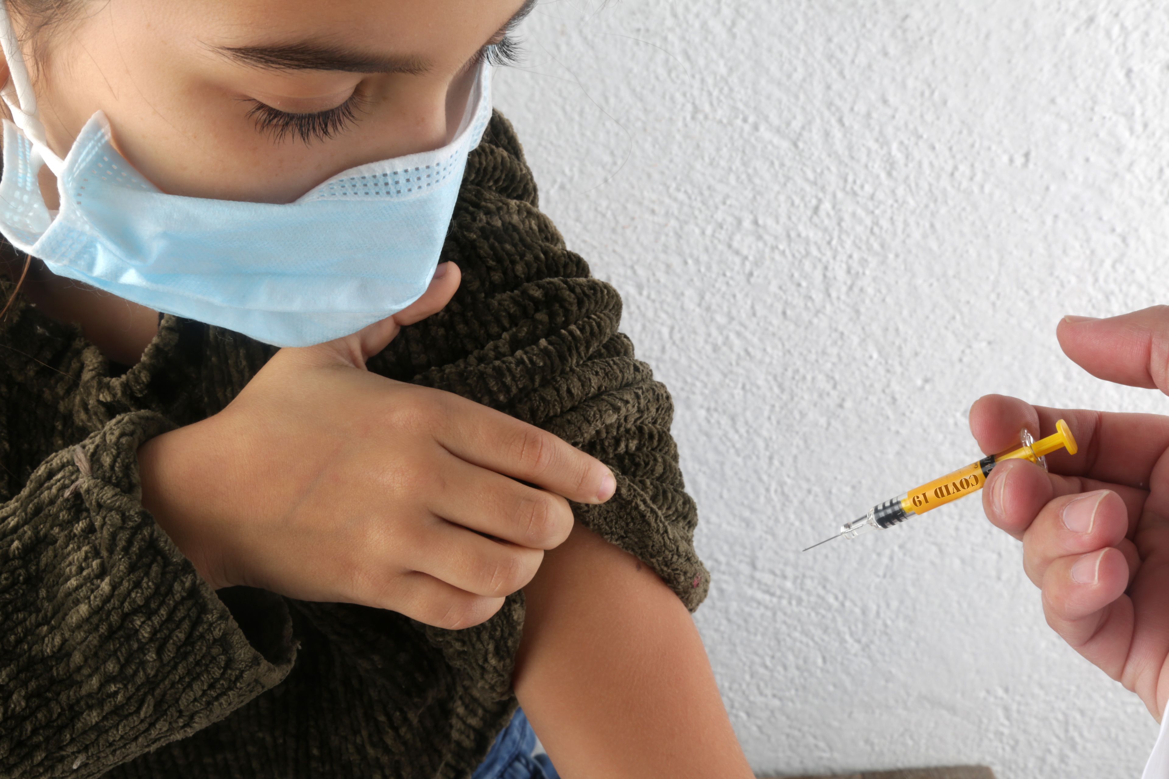 Image of a young girl being vaccinated Immunizations