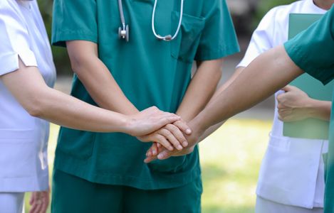 Medical Staff putting hands together Community Outreach Services