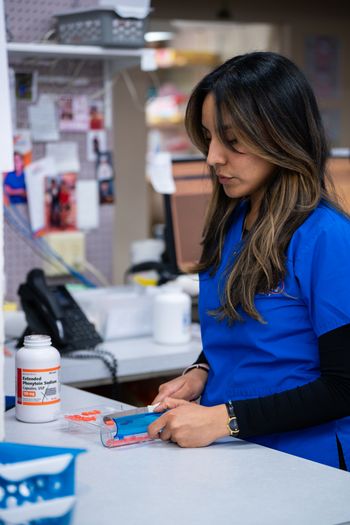 Woman working in a pharmacy Our Team