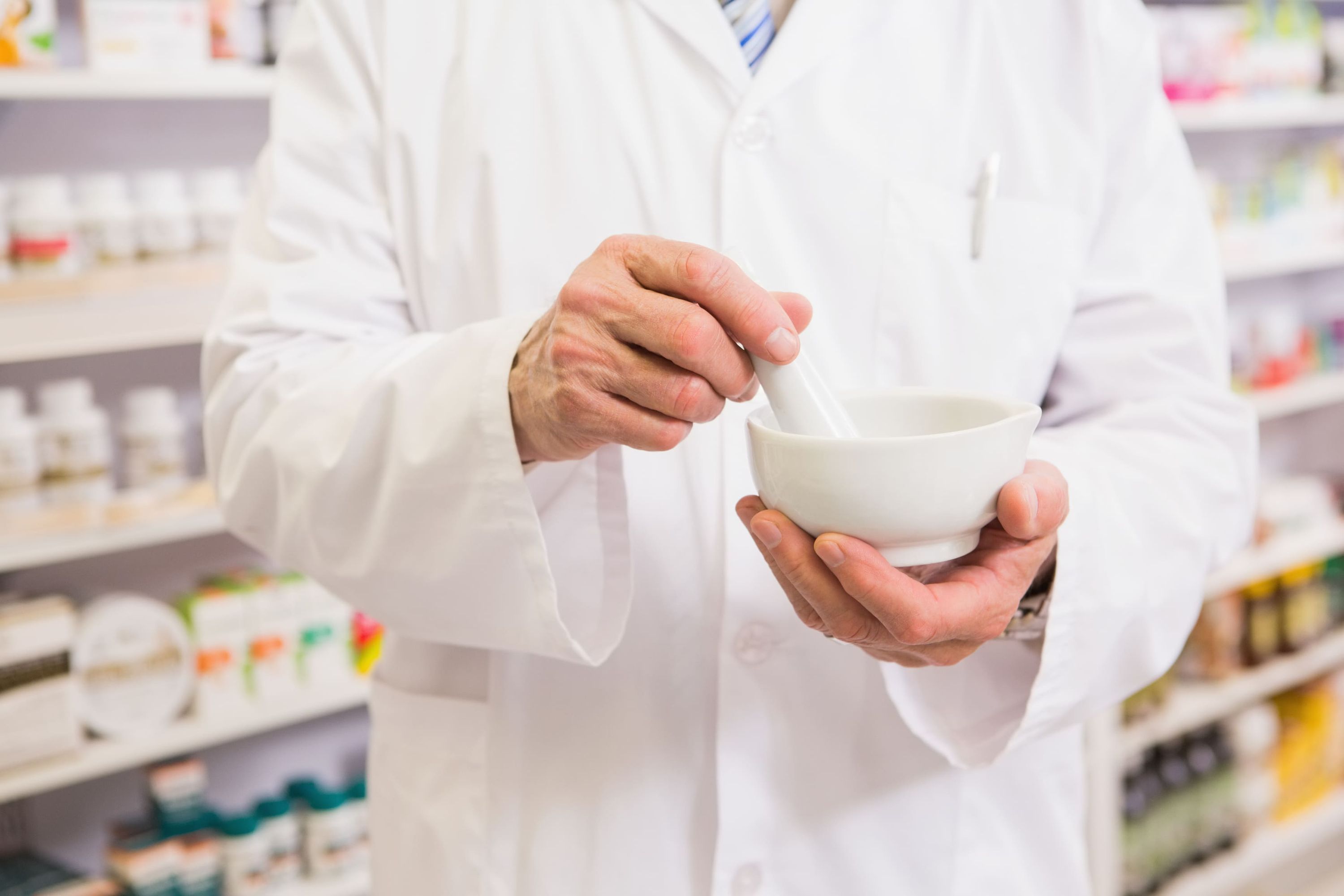 Pharmacist with a compounding bowl Trust Us With Your Health