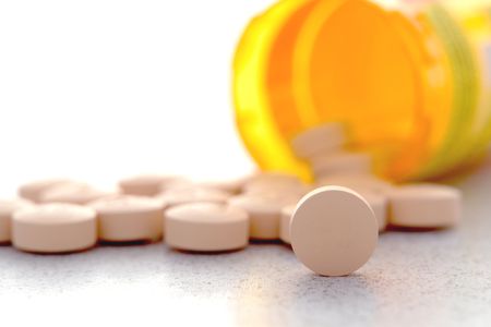 Medicine spilling out of a container Medication Assisted Treatment