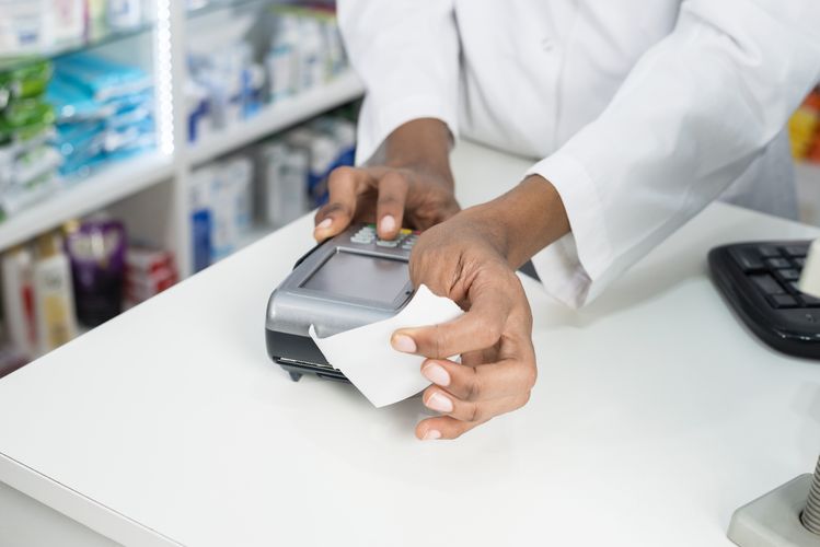 Pharmacist taking payment Billing & Insurance