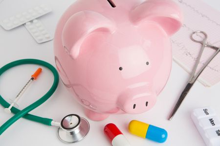 Medicine, a stethoscope and a piggy bank Medication Savings