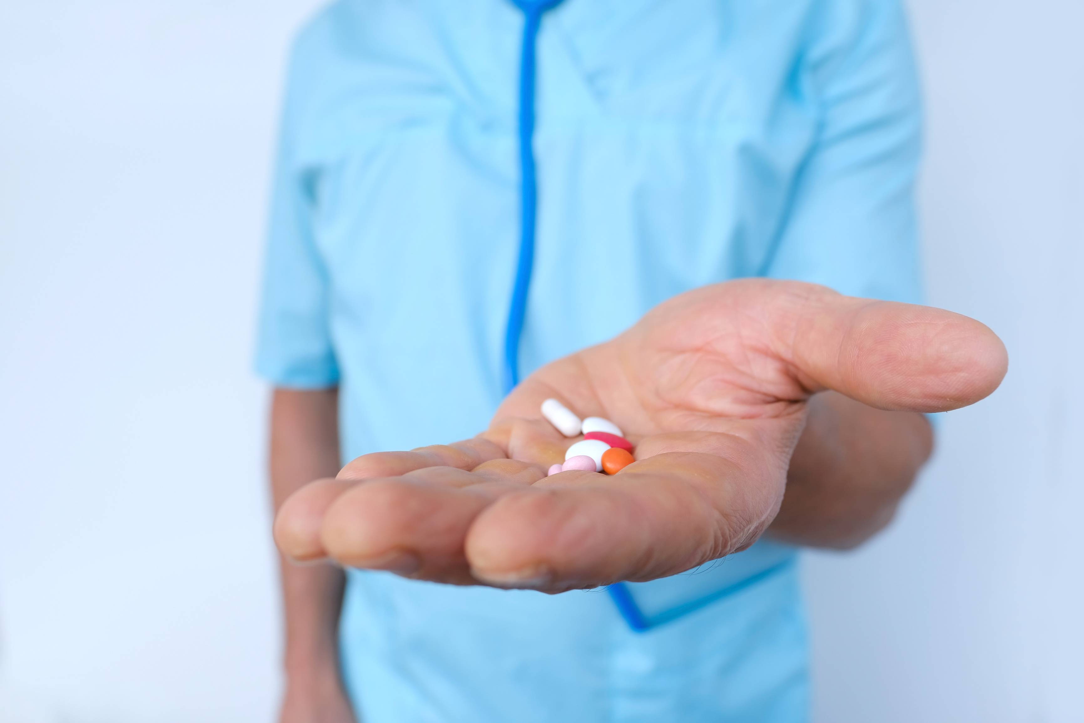 We can help you manage your medications and health conditions Person holding out medications