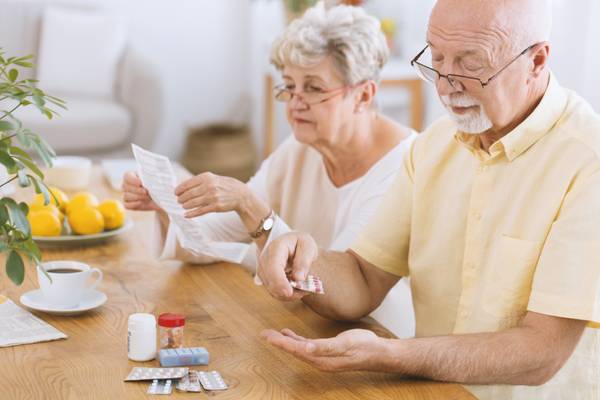 Elderly couple checking medications