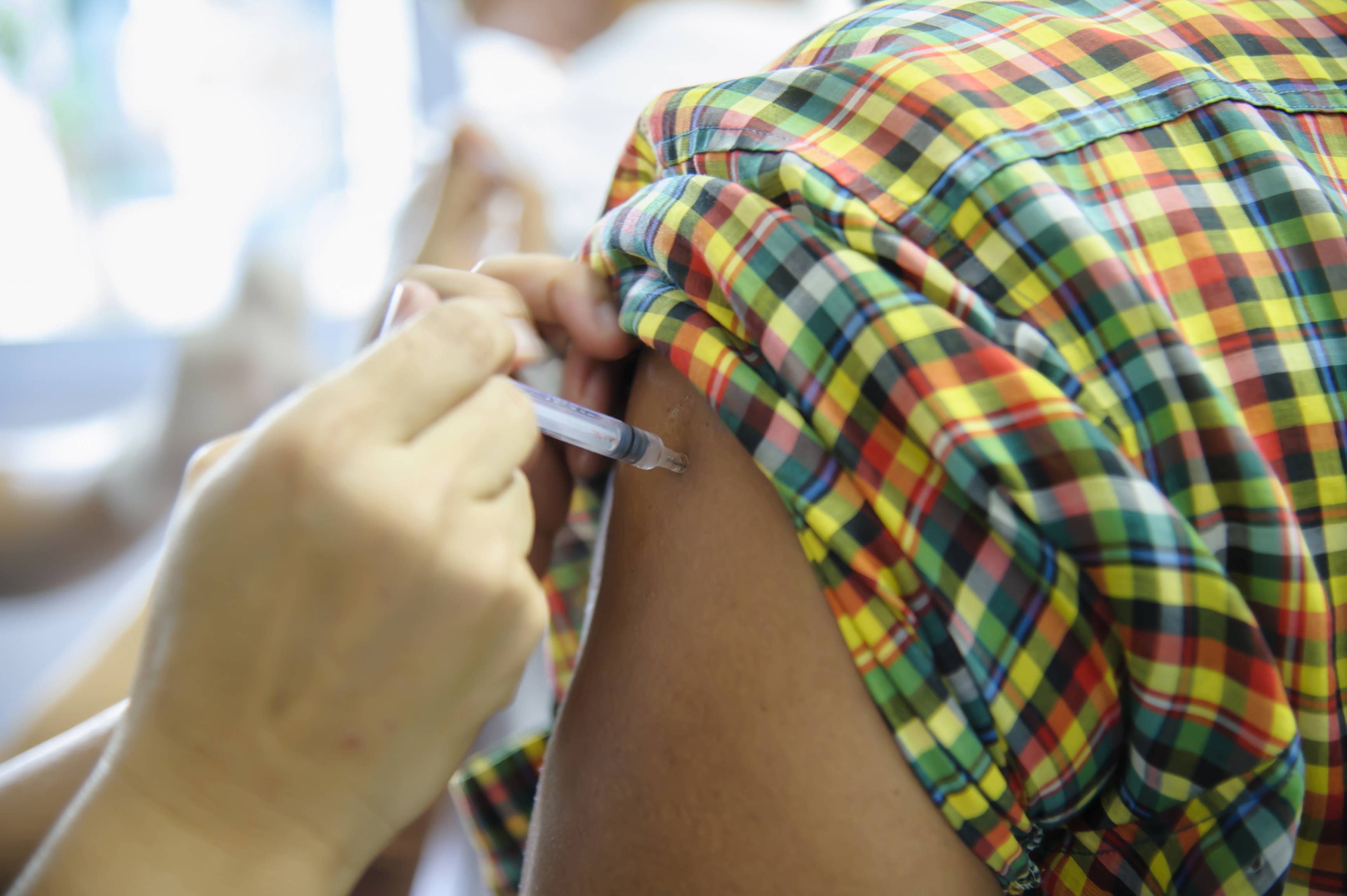 Person getting vaccinated Person getting vaccinated