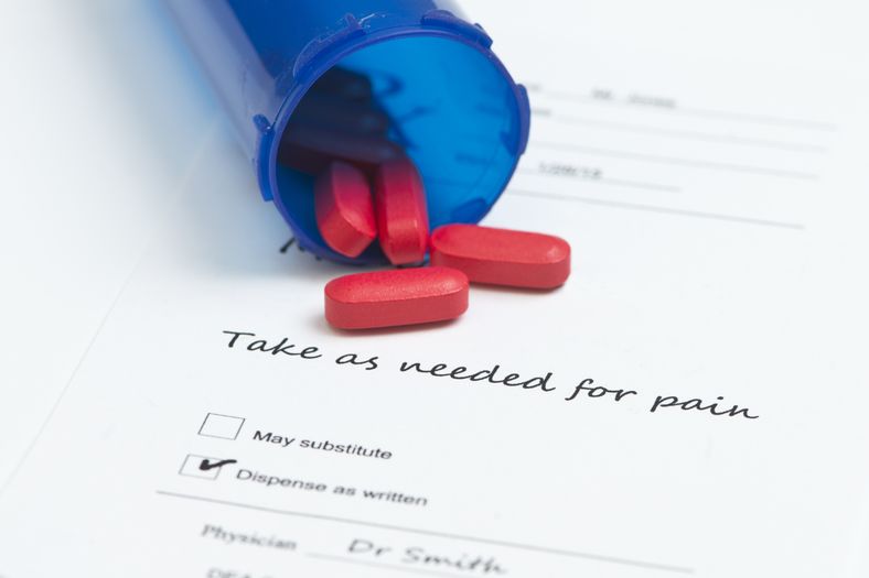 Medicine spilling onto a paper with instructions Medication Therapy Management