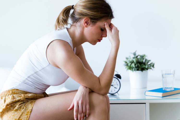 Woman tired with a headache Signs and Symptoms