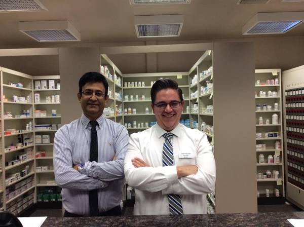 Two pharmacists in a pharmacy Pharmacy Services