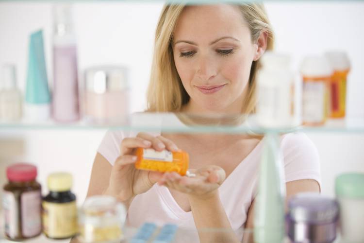 Woman taking medicine Nutrient Depletion Counseling
