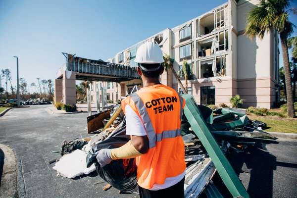 Cotton GDS standing outside damaged hotel in Panama City, FL