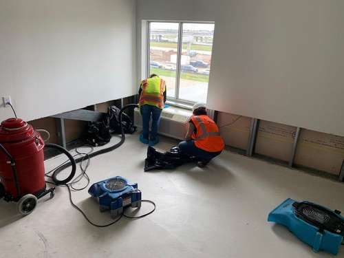 Cotton workers drying and dehumidifying a room structural drying and dehumidification