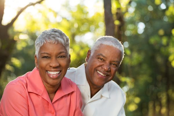 Older black man and woman smiling and laughing