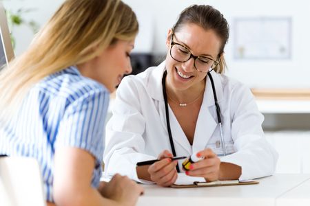 Pharmacist looking over paperwork with a female patient