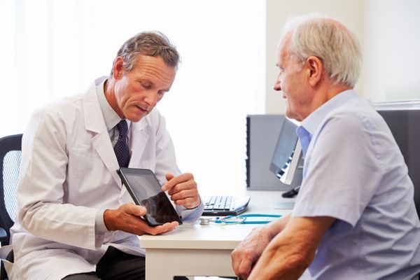 Doctor discussing Medicare with an older man