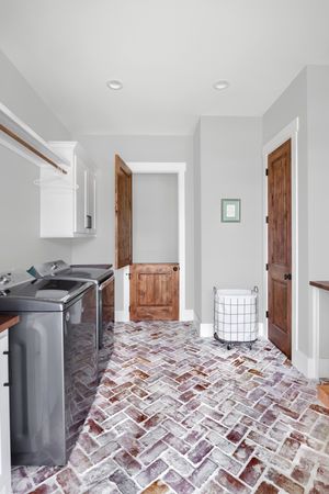 White-washed brick laundry room floor