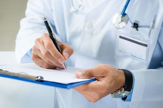 A pharmacist writes a prescription Pharmacy