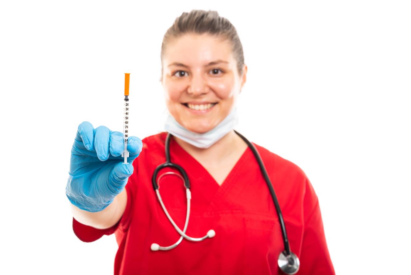 Image of a healthcare professional showing a syringe with vaccine Immunizations