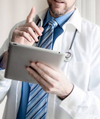 doctor-using-computer-tablet-to-consult-with-patient.jpg