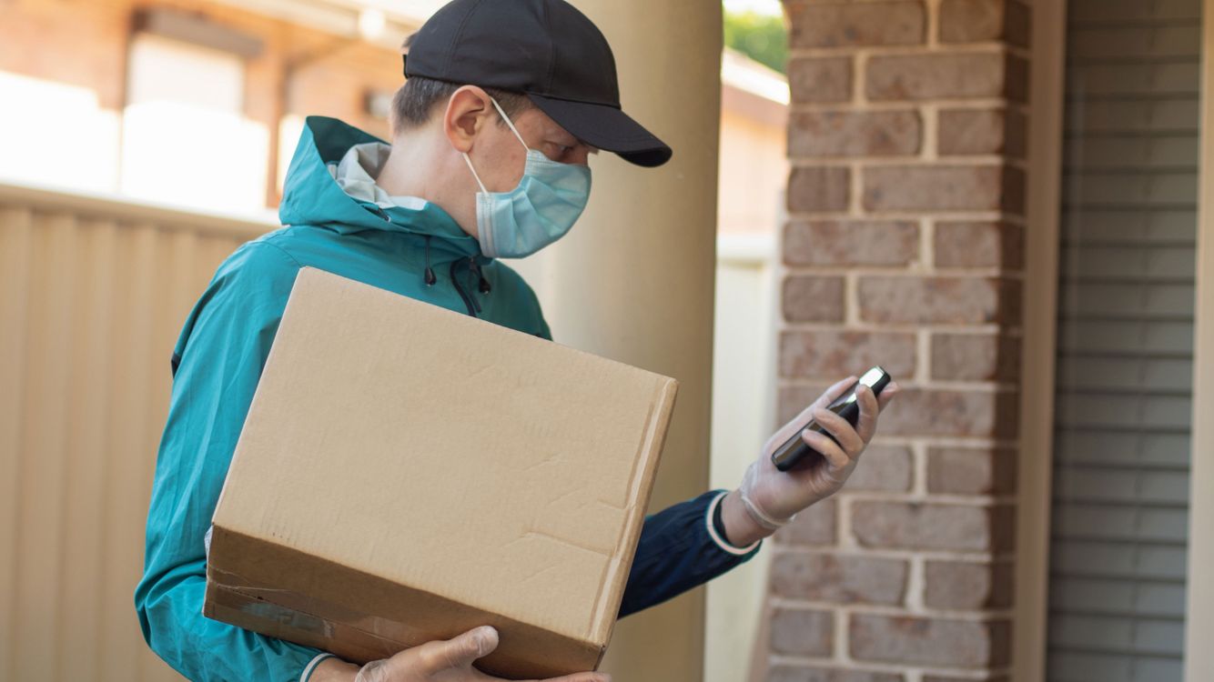 pharmacy-delivery-man-with-box-iStock-1219082613.jpg