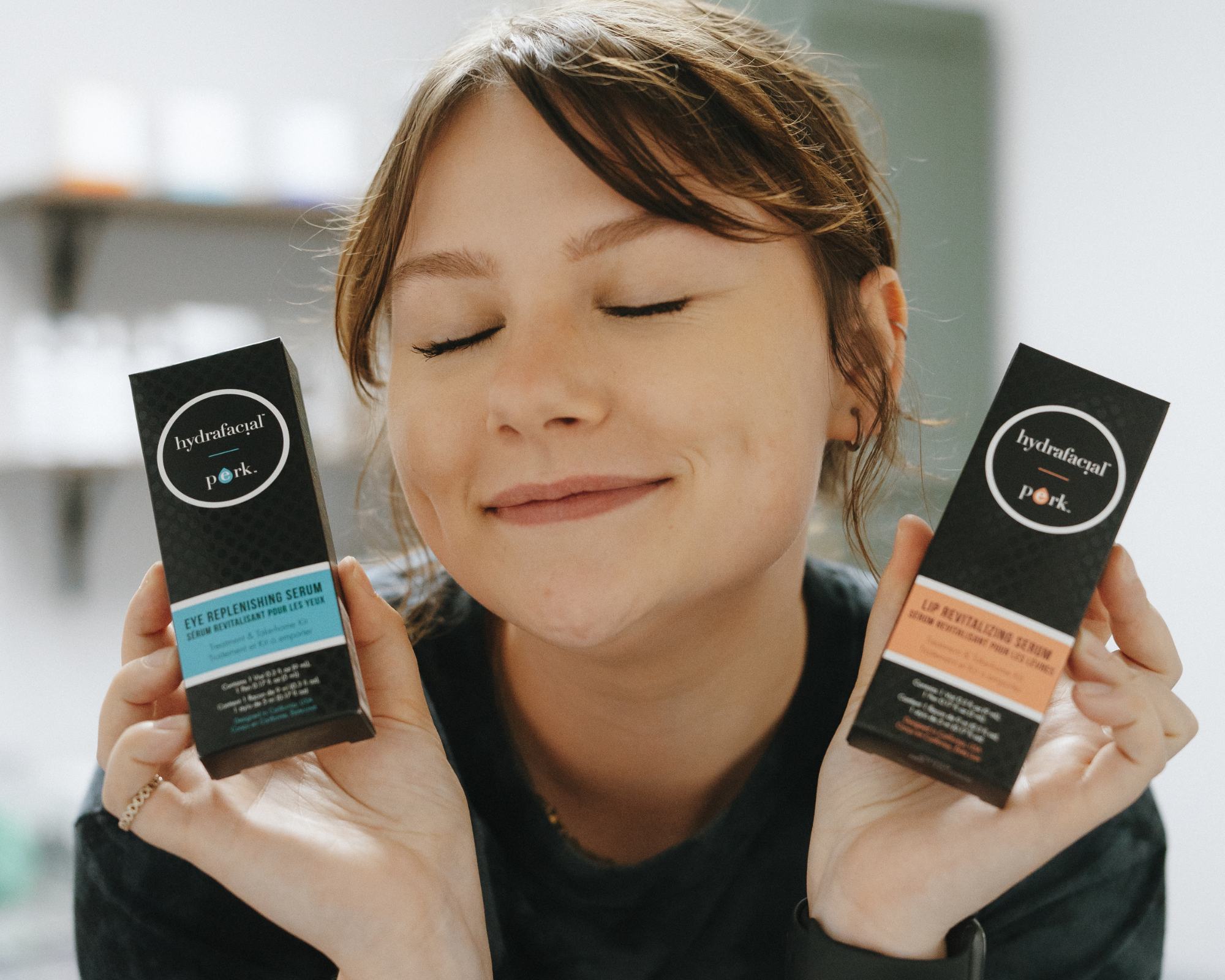 A Haus of FIDI esthetician in Pensacola holds Hydrafacial Lip and Eye Perk enhancement products used to hydrate, smooth, and brighten delicate skin during facial treatments. Esthetician holding Hydrafacial Lip and Eye Perk enhancements