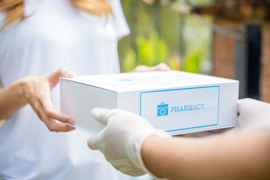 Delivery person handing over a prescription box to a patient. Free Delivery